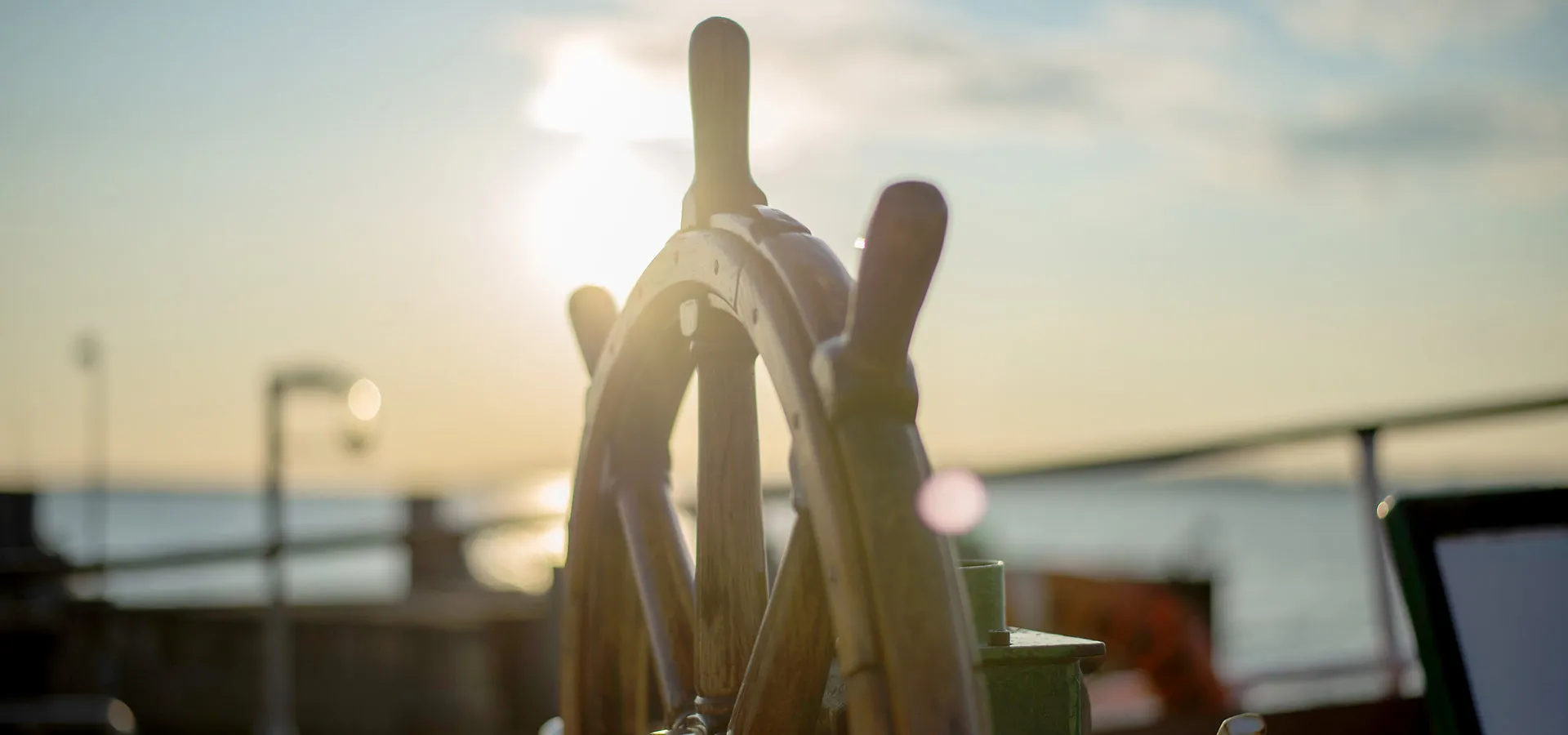 Steuerrad eines Schiffs bei Sonnenuntergang